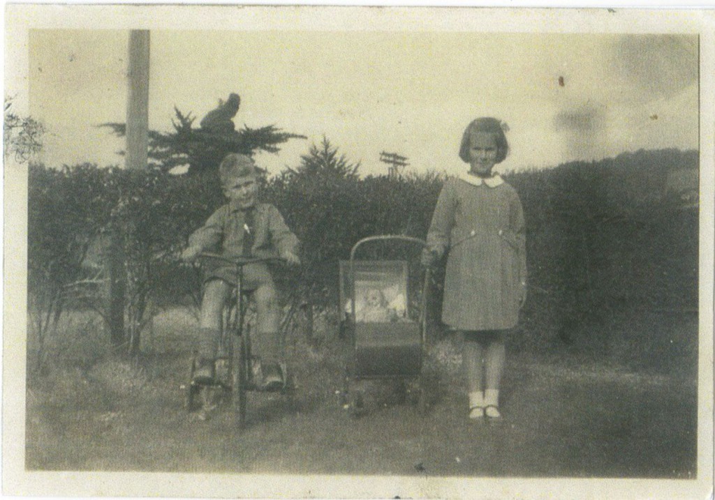 Grant and Barbara with trike and pram made by Syd. Appox 1946.