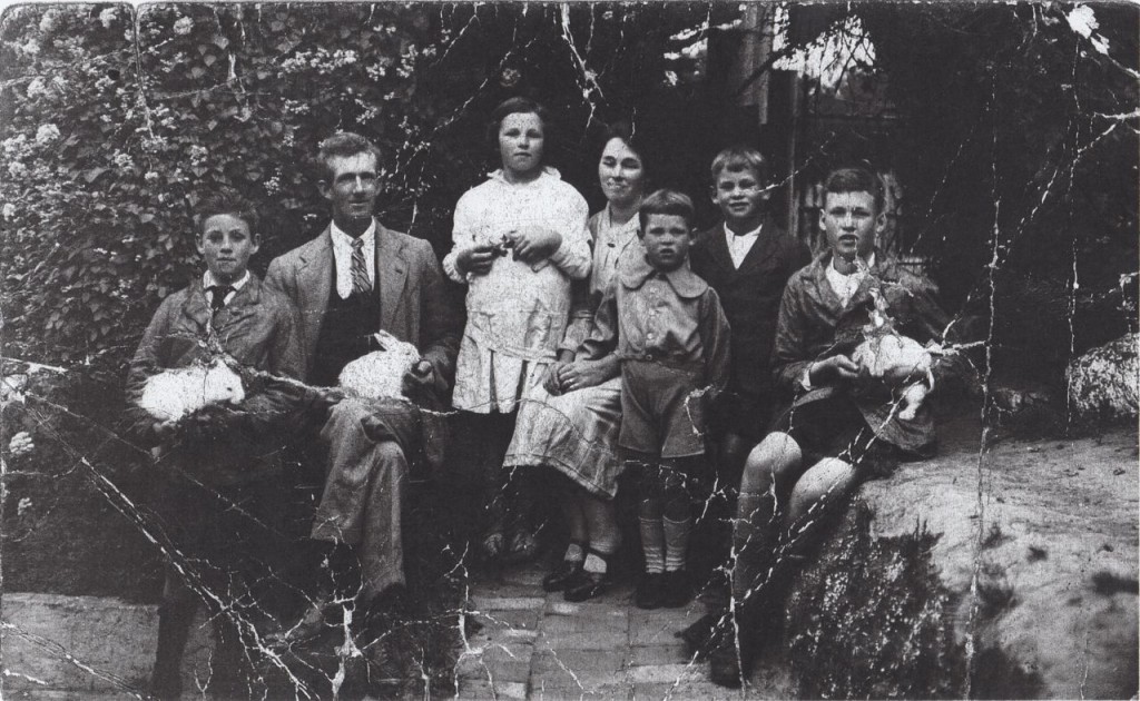 Henshaw Family at Bridle Path home - Lyttelton, with their white rabbits. Left to right: Charlie, Arthur, Kitty, Katy,Wyndam, Roy and Syd.